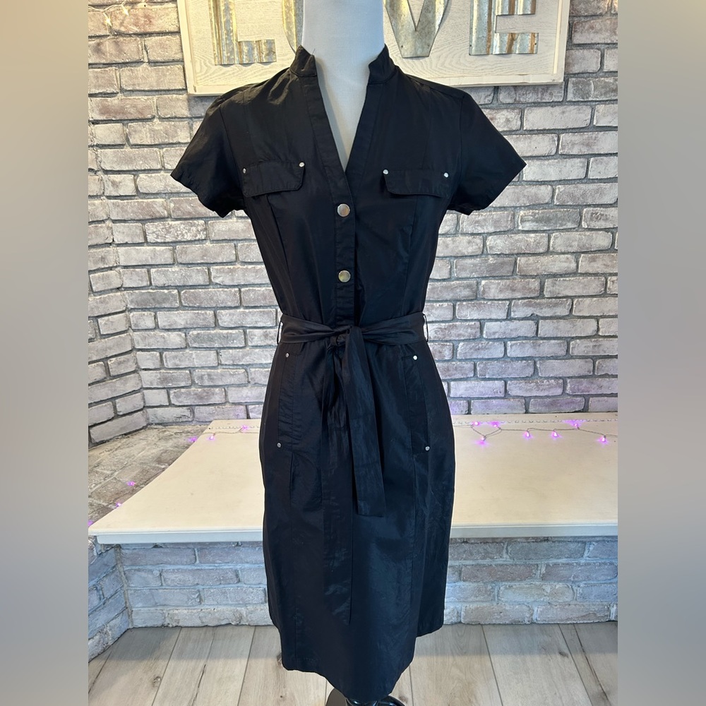 Black cap sleeved knee length dress.
